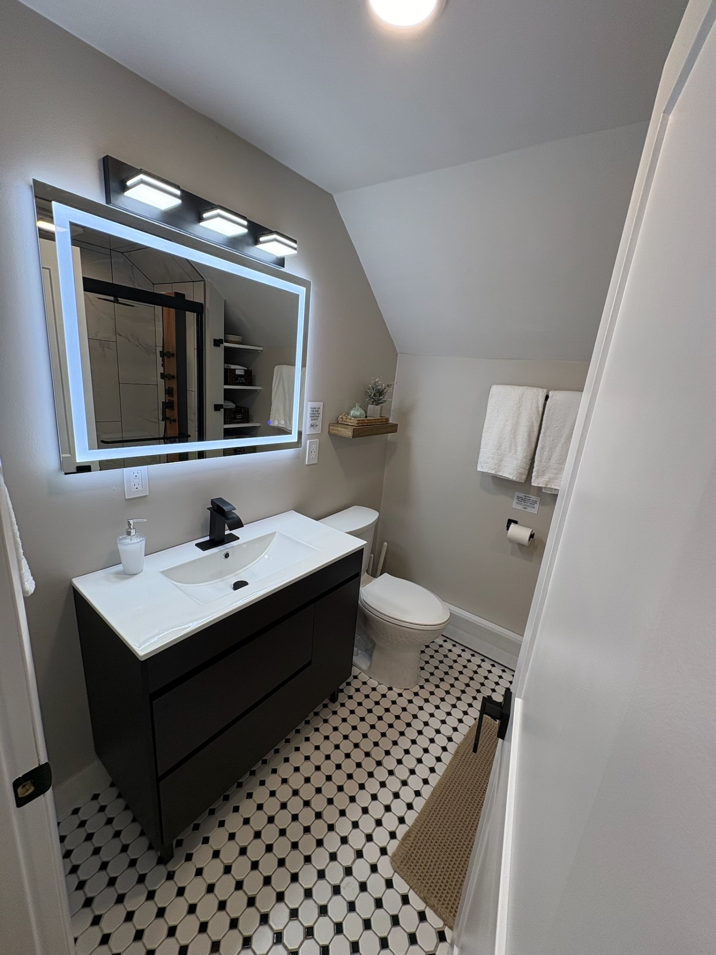 Bathroom with lighted mirror